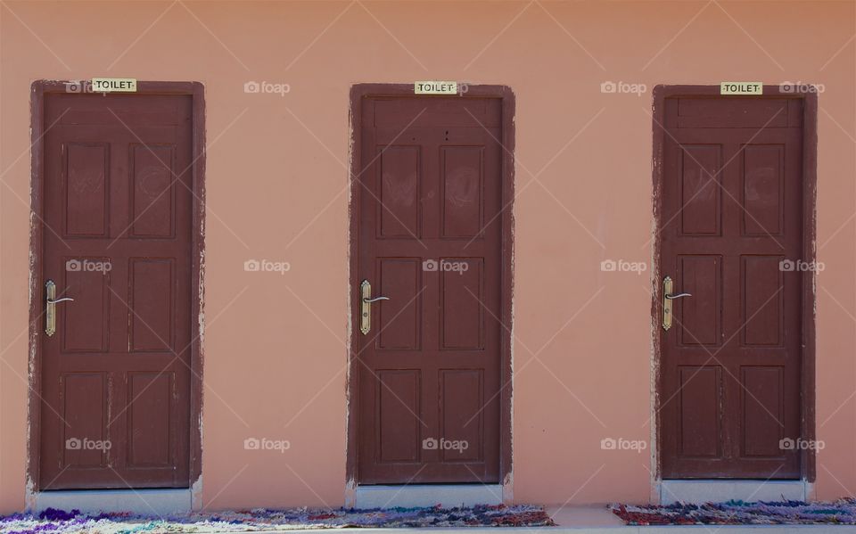 A block of outside closed doors which are marked by toilet signs near Essouira,, Morocco, North Africa.