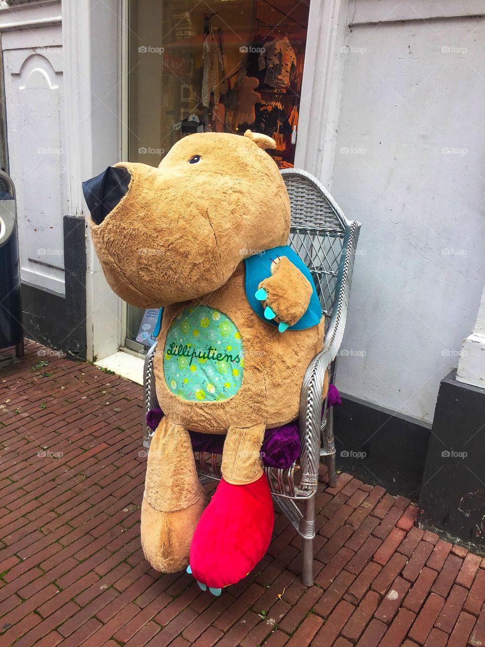 Large stuffed toy sitting on a chair 
