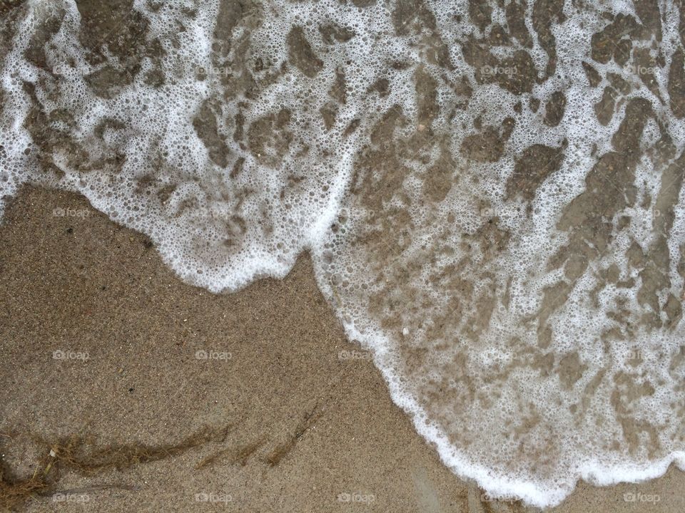 Waterline. Waves coming up on the beach