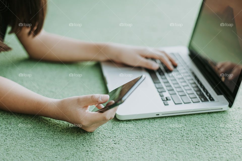 Girl on laptop and phone 