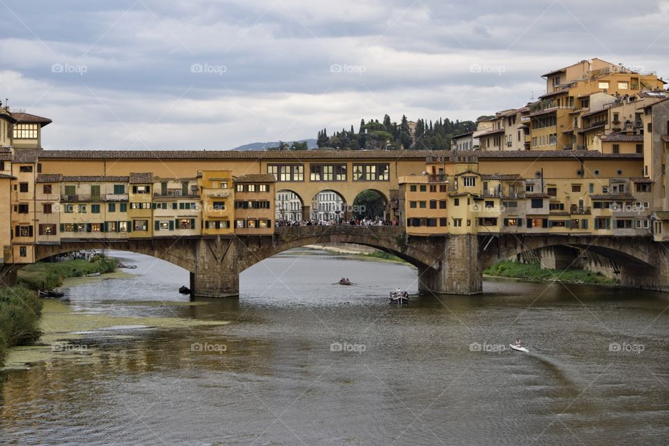 View of Ponte Vecchio across river Arno in Florence Italy