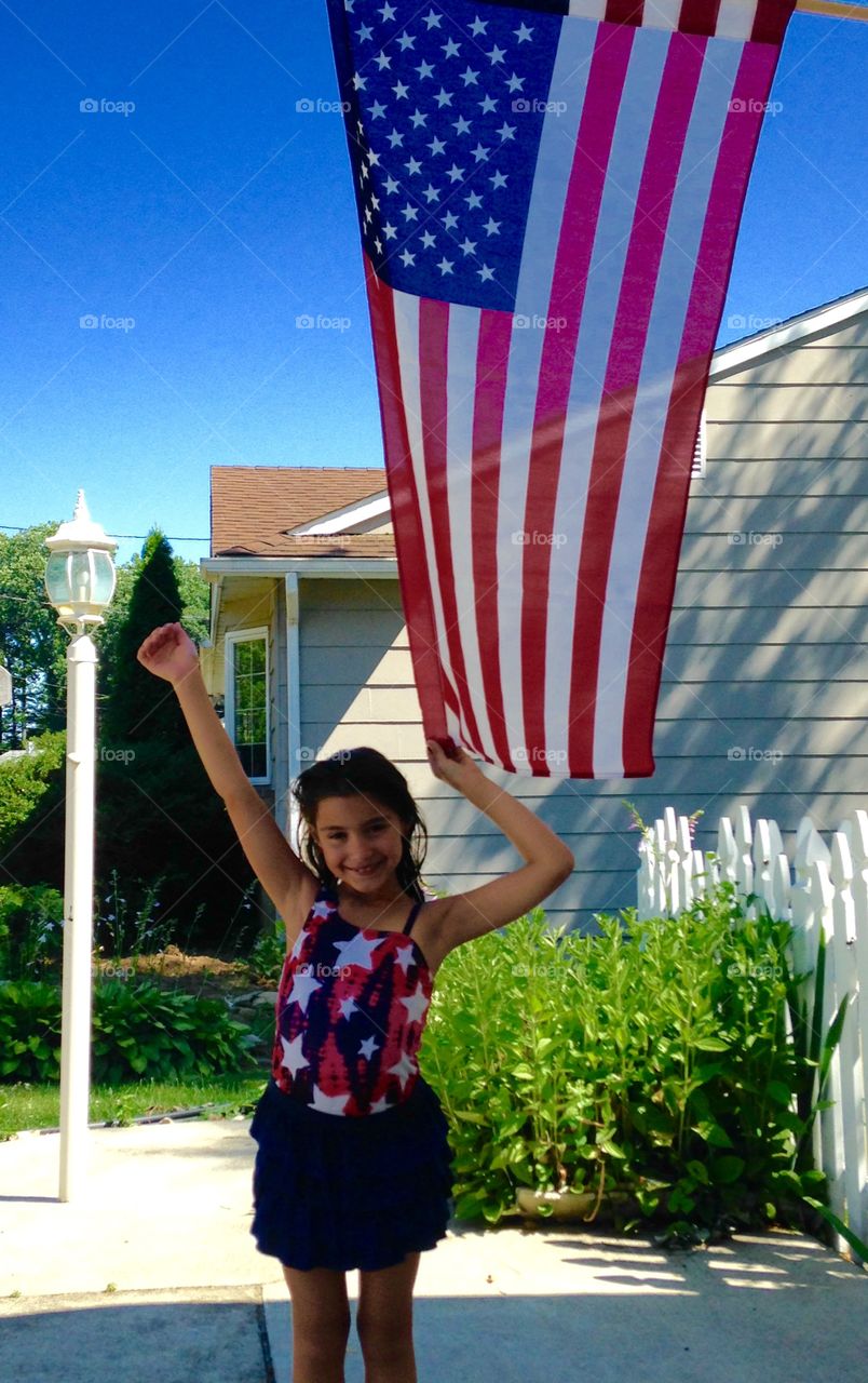 Smiling girl showing american flag