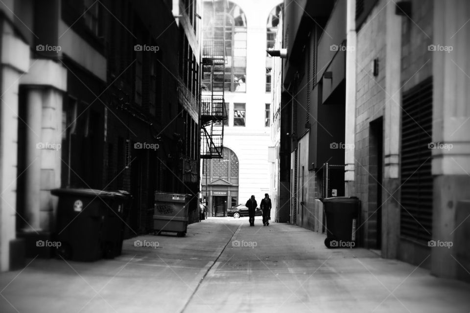 two men walking down an alley