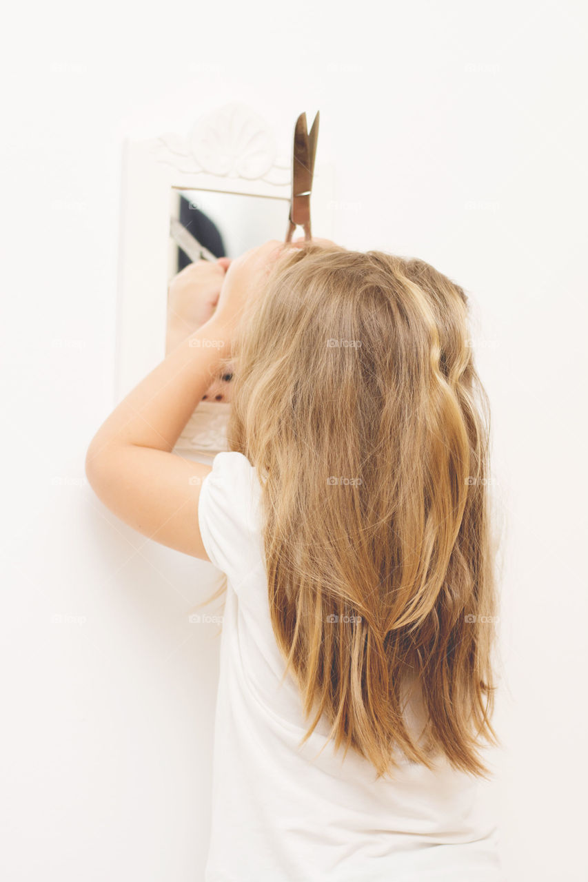 Little girl cutting hair