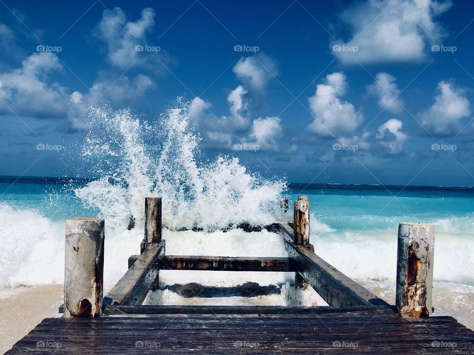 Strong ocean waves slamming the pier 