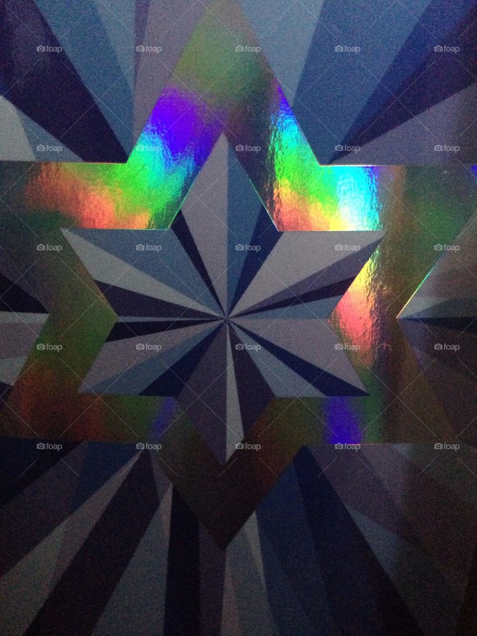  Foil Ornament with light reflecting off of it to form the spectrum of prismatic colors like a rainbow.