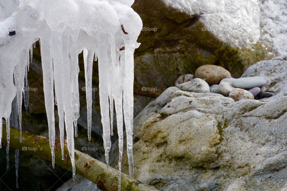 Icicles over rock