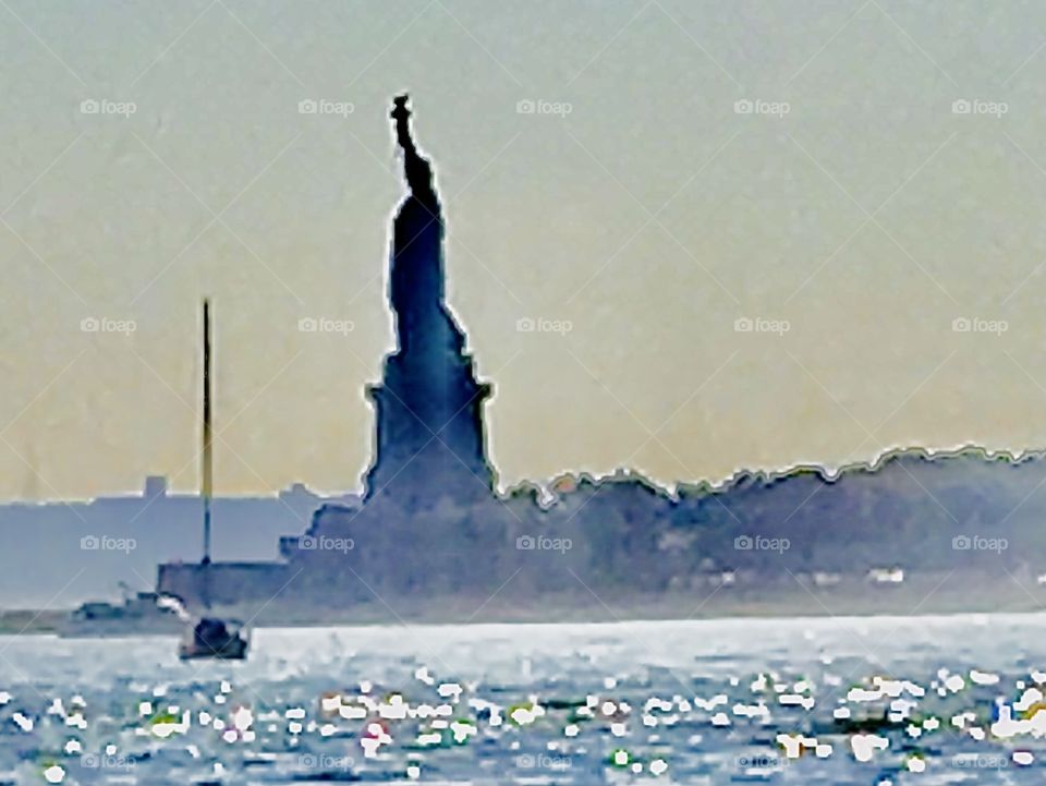 The „Statue of Liberty“ on the misty waters of the Atlantic Ocean can be seen only from afar when traveling near it by ship or by boat. We used a zoom lens to get this close up. 2018. Hypnotic Productions