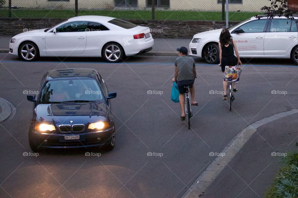 Street shot of people,cars and bicycles
