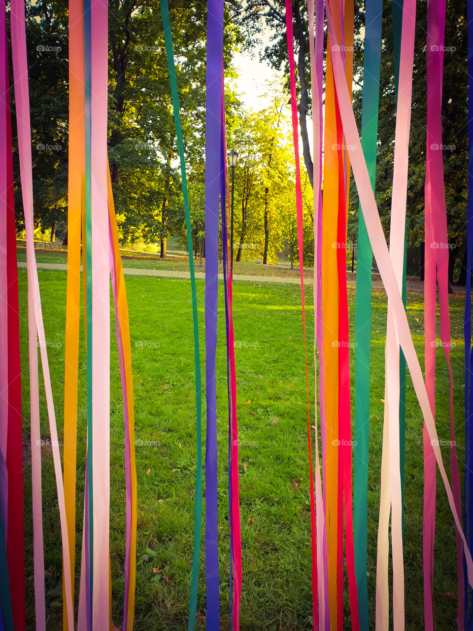 The beginning of autumn, landscape.  View of the park through multi-colored satin ribbons