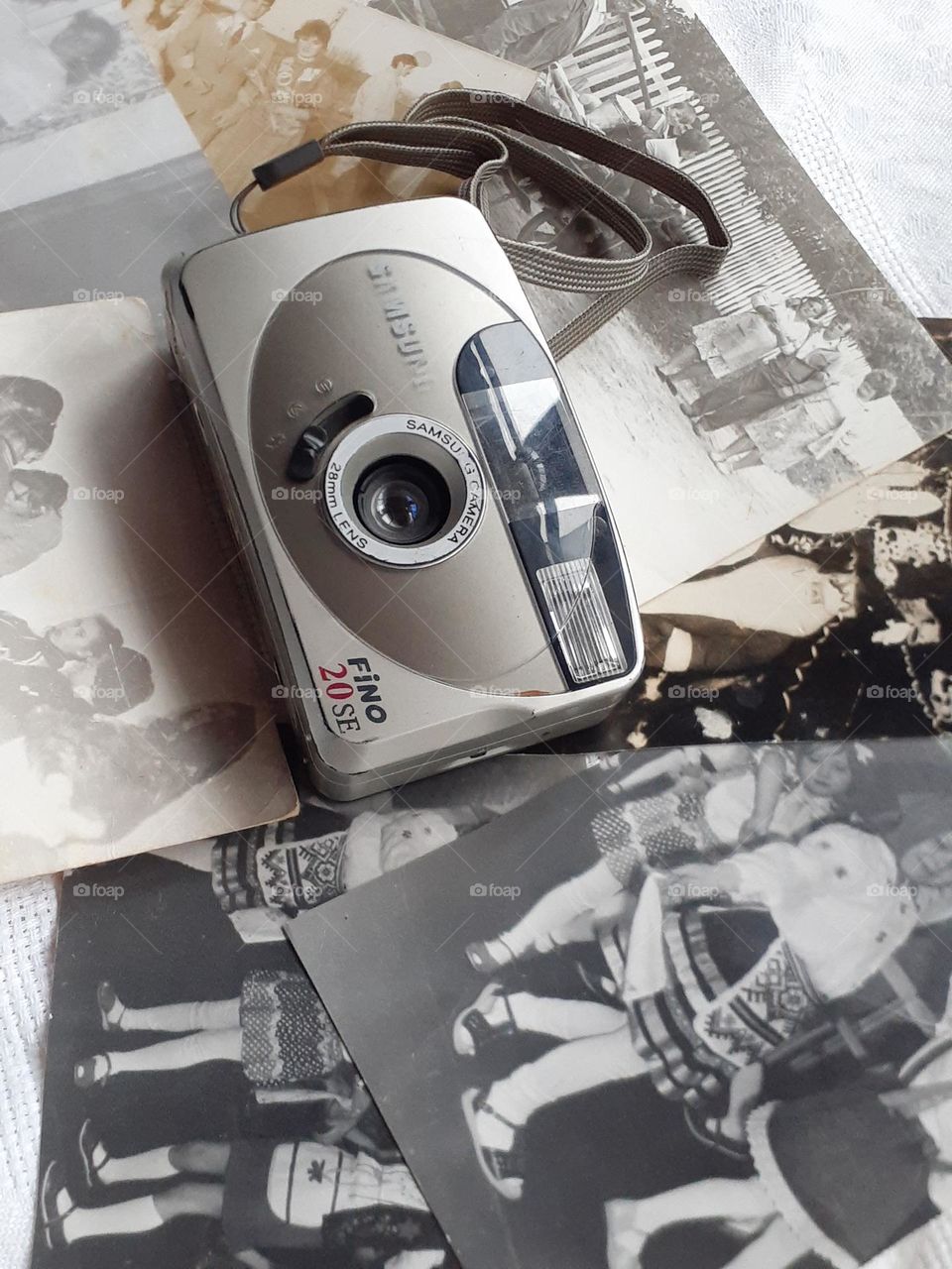 retro camera and old photos of people and children near it taken with old cameras