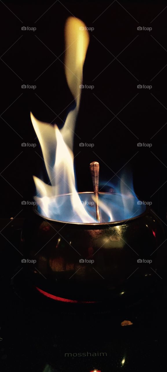 Reach For The Flame . A pot filled with tall flames.