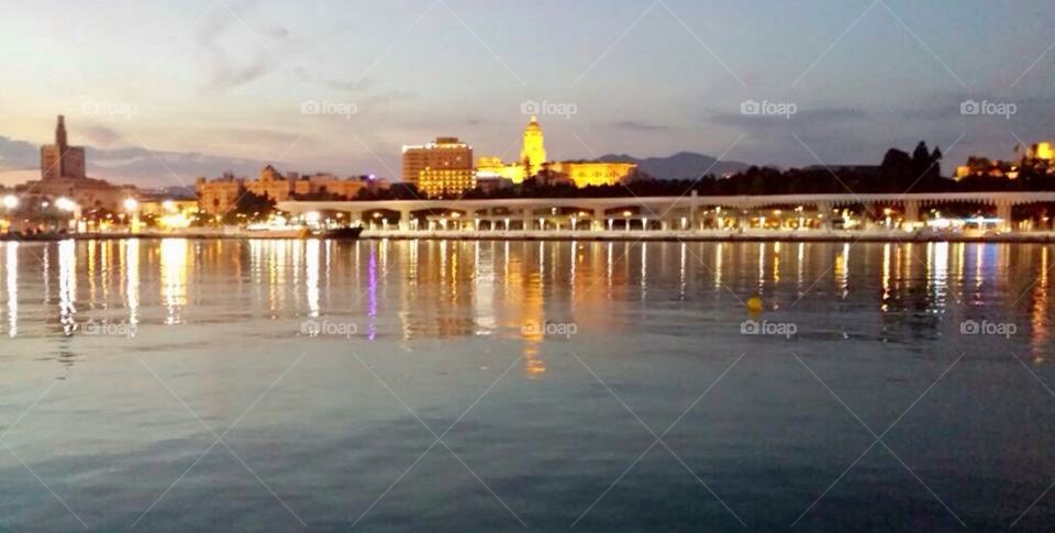 Malaga port in the dusk, early evening with reflections from the water 