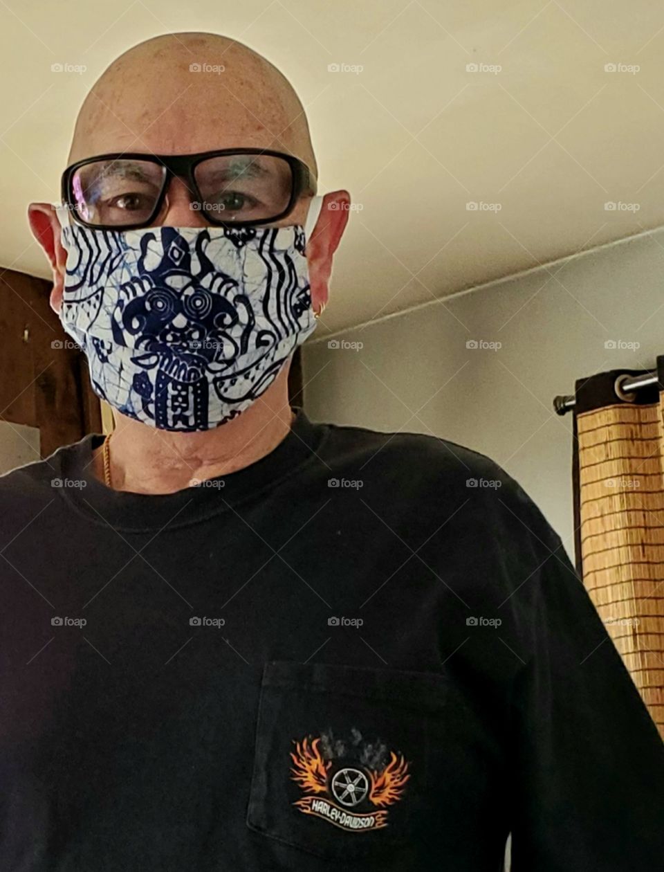 Man wearing mask getting ready to go out & about to get errands done around town. He has eye protection & face protection on.