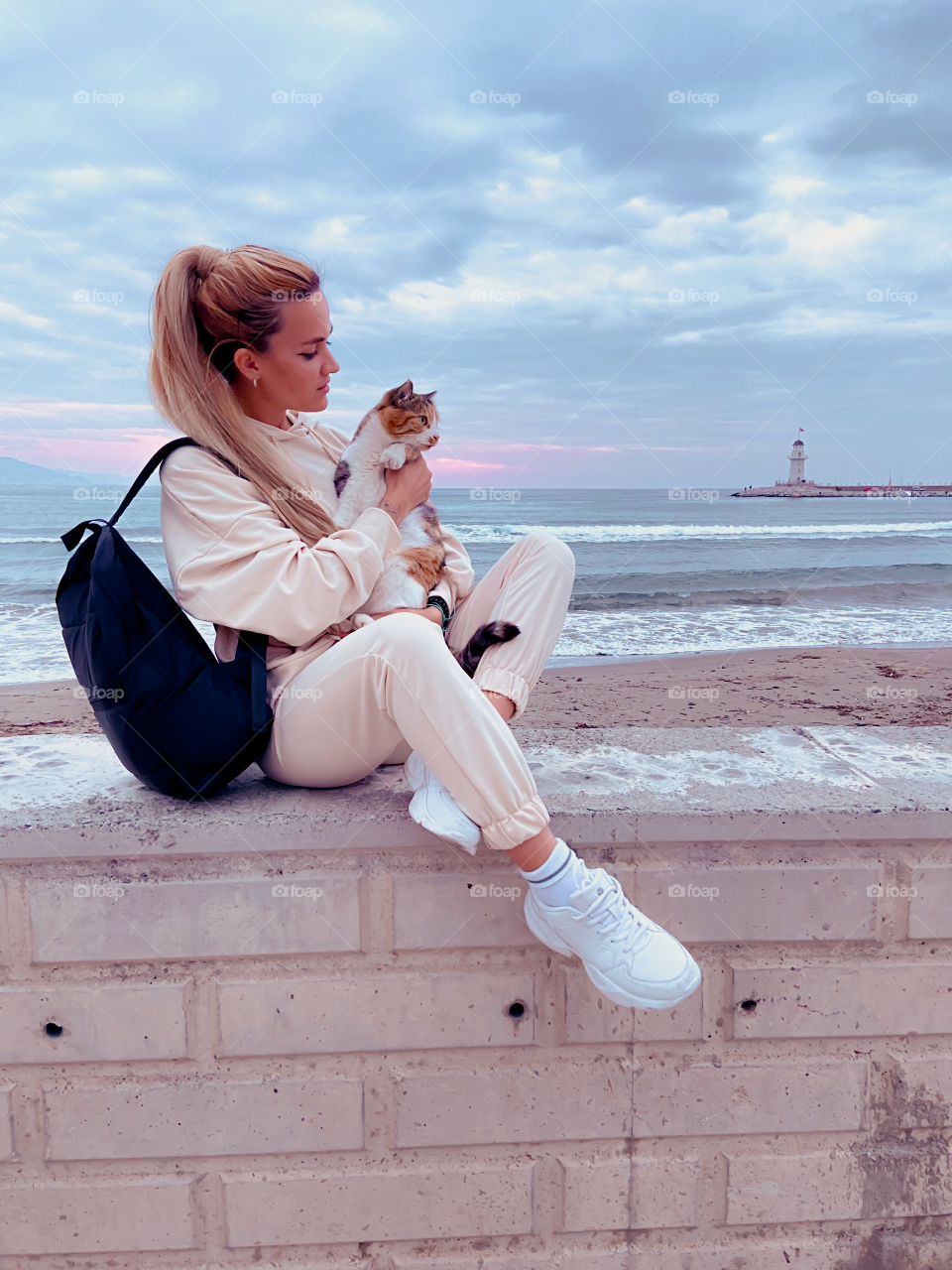 Girl and cat on the beach 