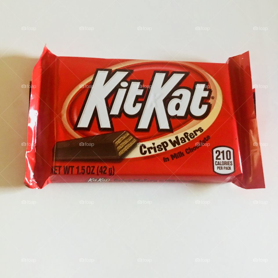 Kit Kat bar on display against a white background, chocolate delicious candy bar. 