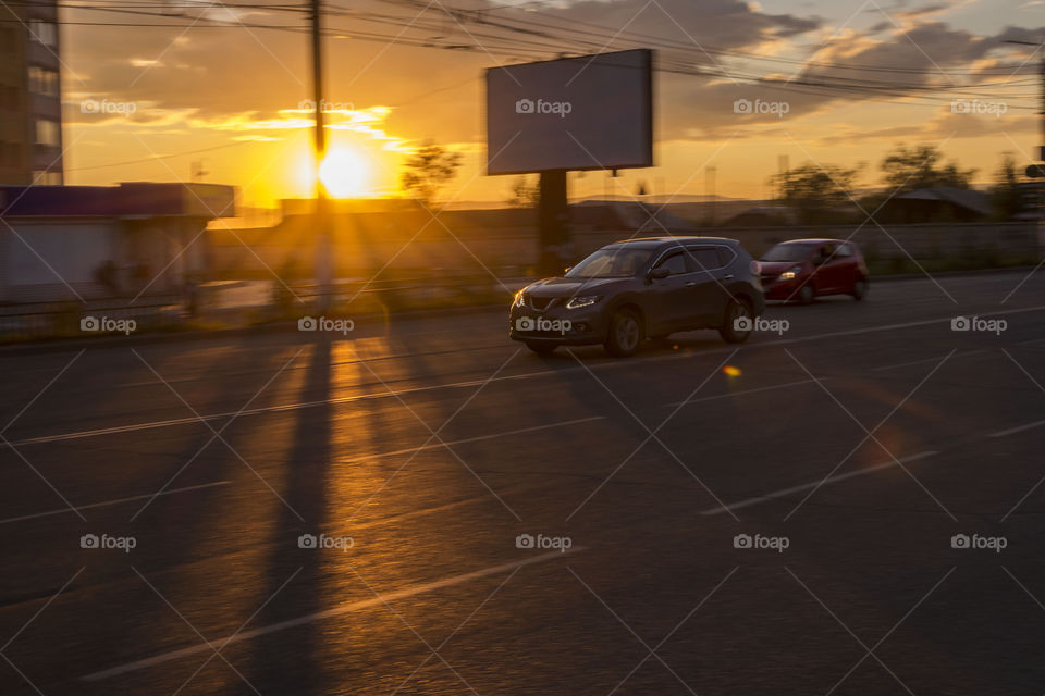 Car in motion on a sunset background