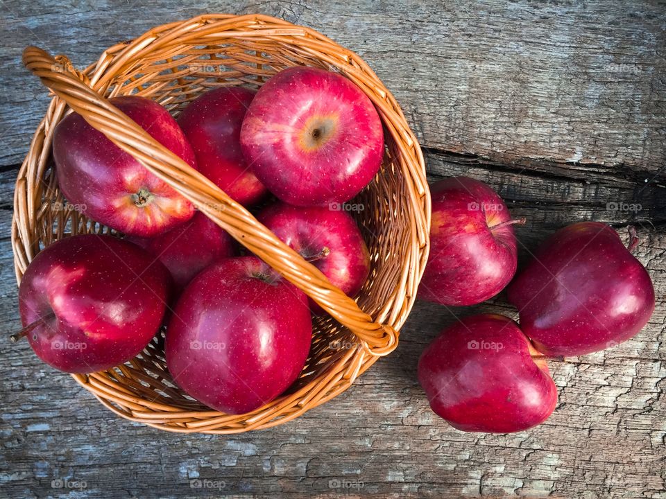 Wooden basket full of red appples