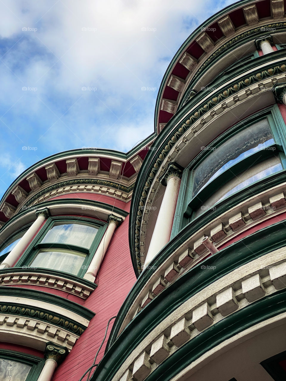 Closeup view looking up at two Victorian “painted ladies” houses of San Francisco 