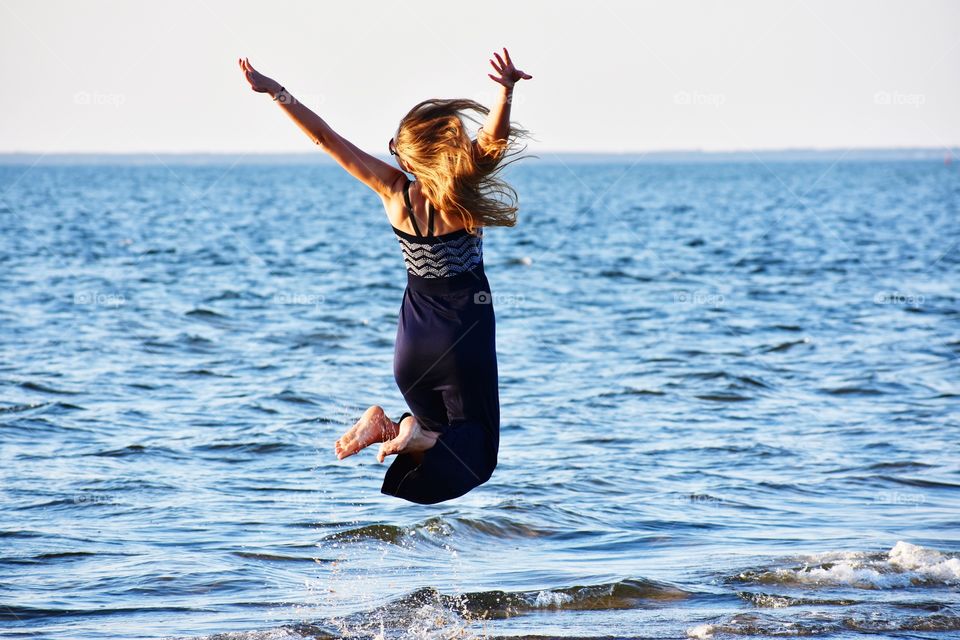 girl jumping at the Baltic sea in rewa