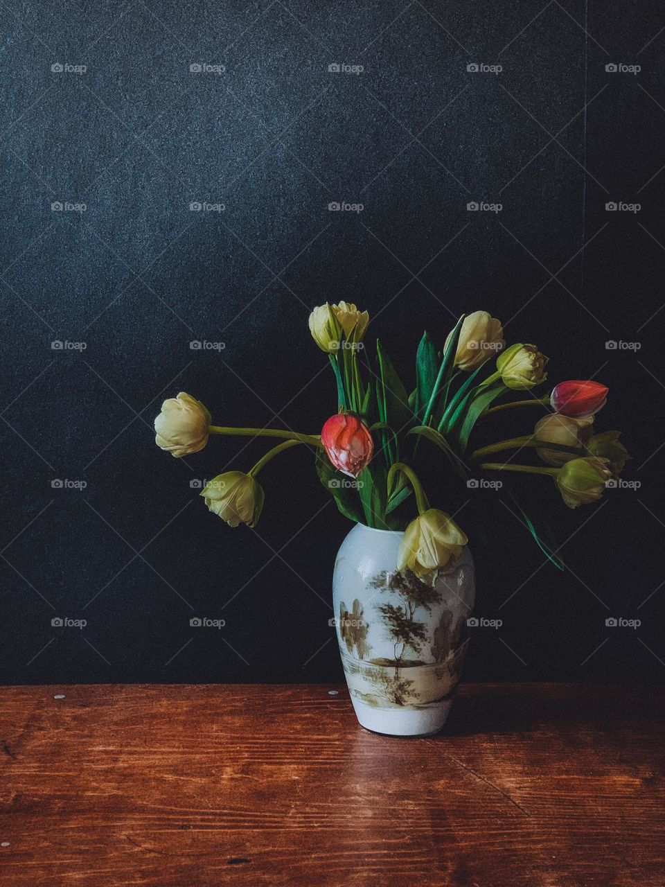 tulips in a vase on a dark background 