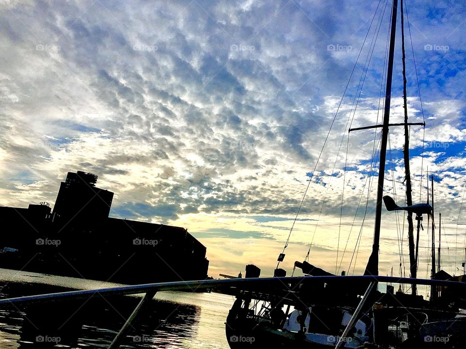 An impressive as well as dramatic view from aboard our sailboat, the „Salvation“ looking out onto Newtown Creek in LIC, Queens, NY during the hours of sunset and upcoming nightfall. 2021. Hypnotic Productions