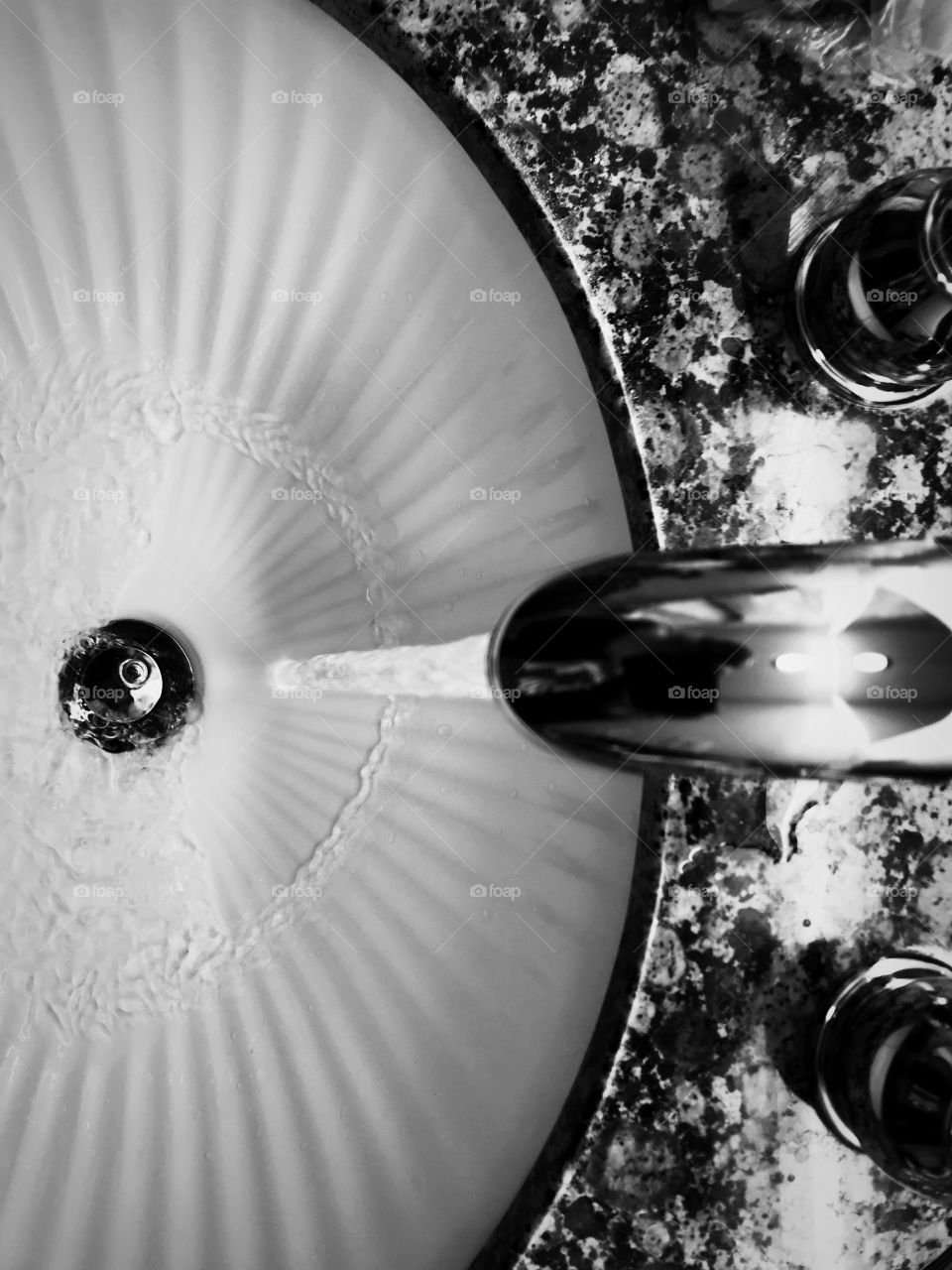 Black and white abstract of sink and faucet