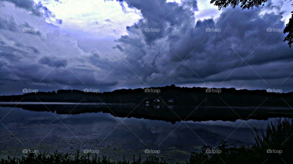 Silhouette of mountain reflected on lake