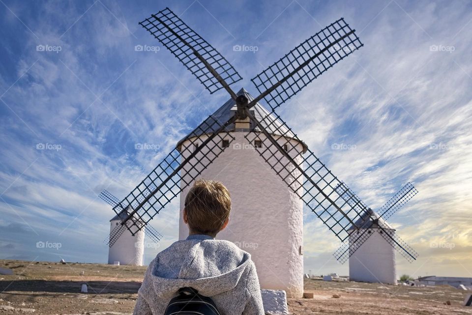 A woman looks at the old windmills