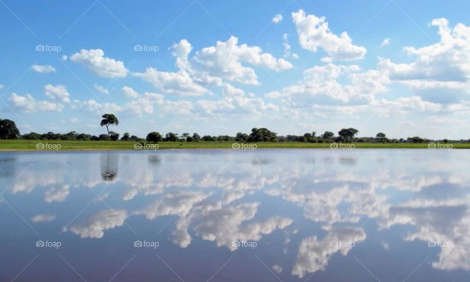Blue sky reflection with clouds in the water