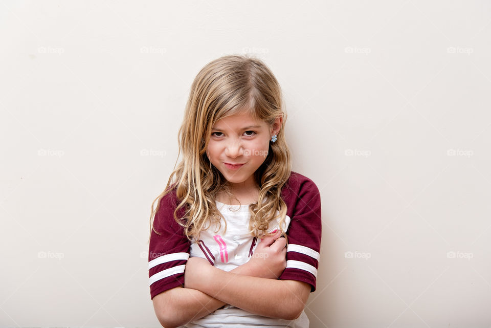 Cute young girl standing with folded hands