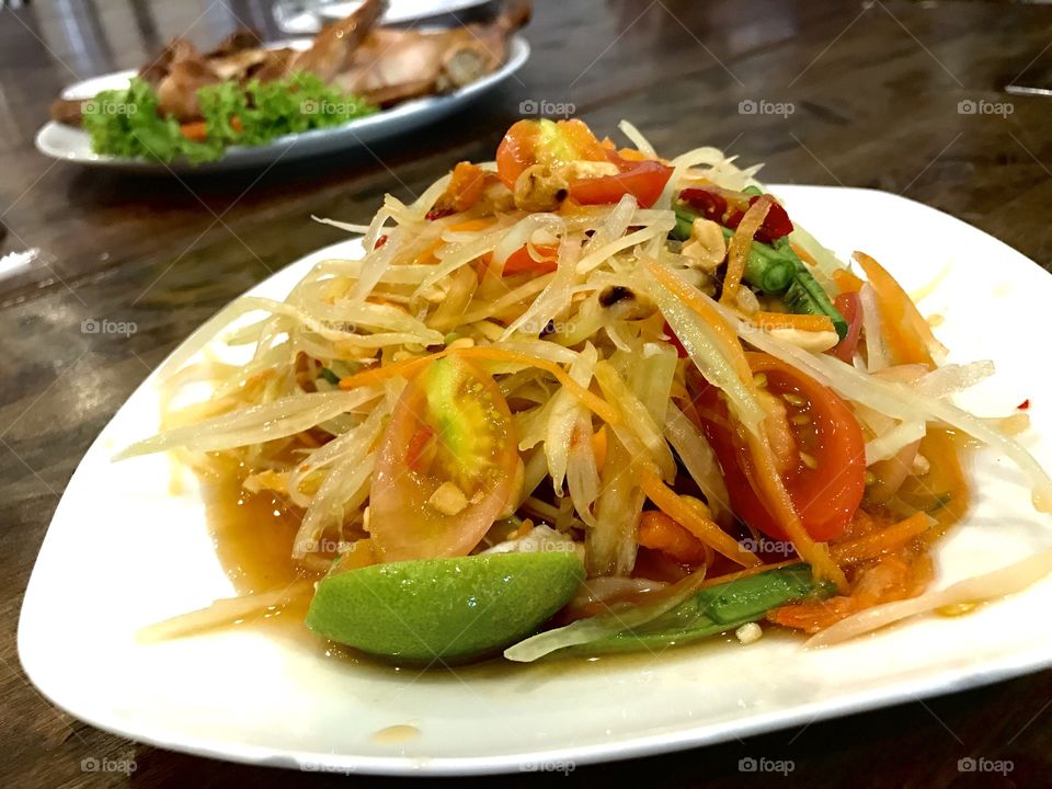 Som Tam or spicy papaya salad, Thai popular food that can be found everywhere in Thailand.