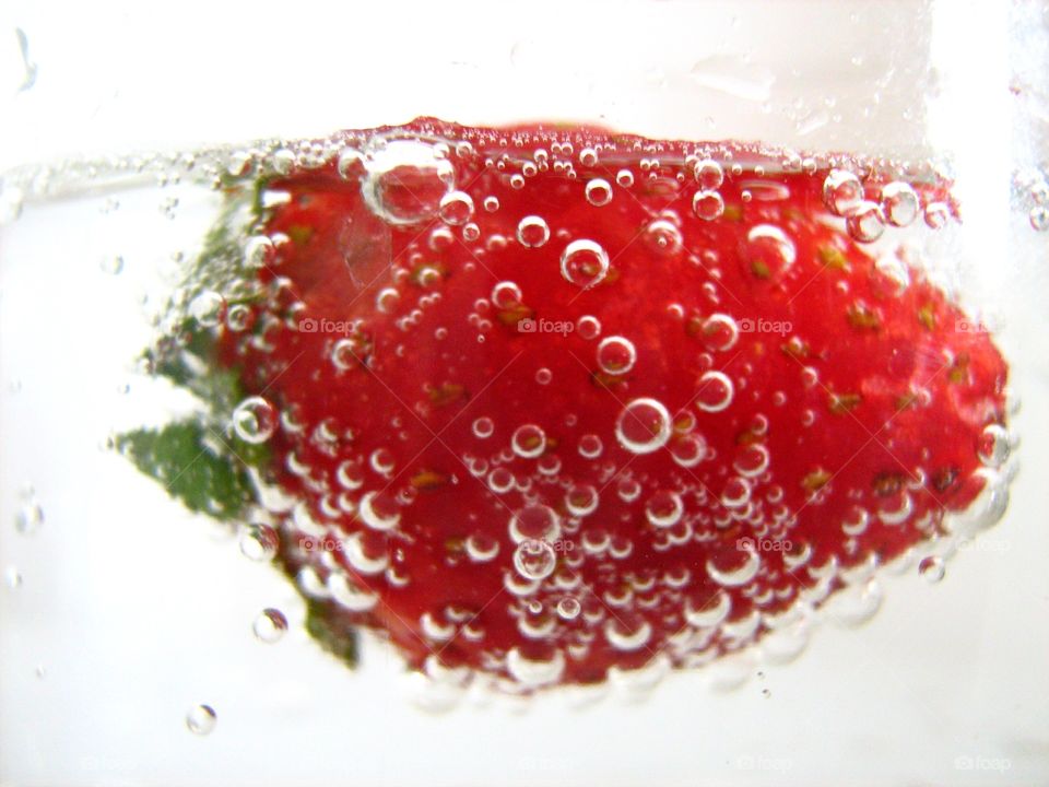 Close-Up Of Strawberry In Champagne