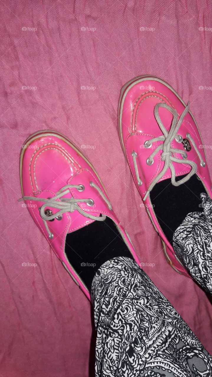 A close-up photo of pink loafers standing on a pink blanket.