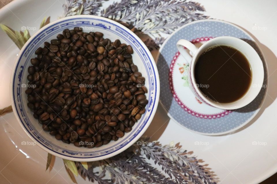 A cup of coffee and coffee beans