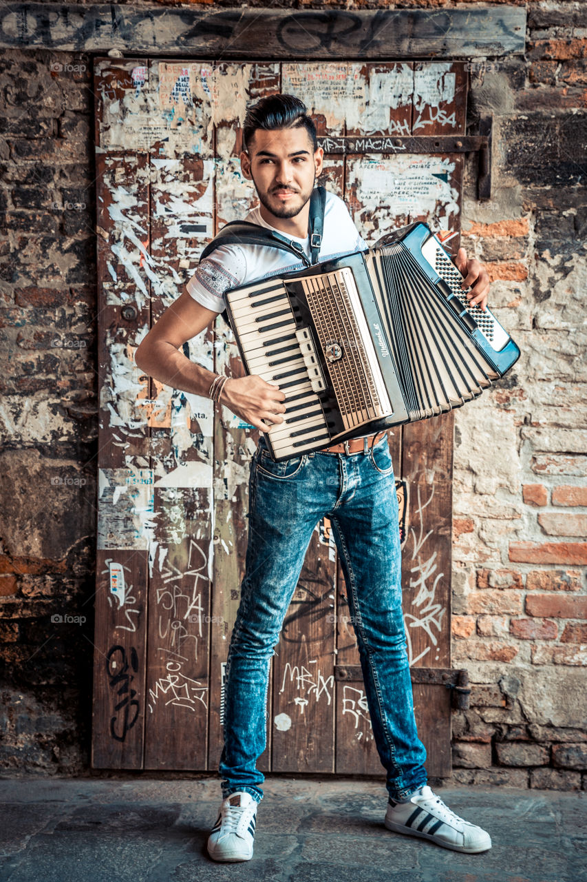 Young Man Accordion Music Player Performing In The Street
