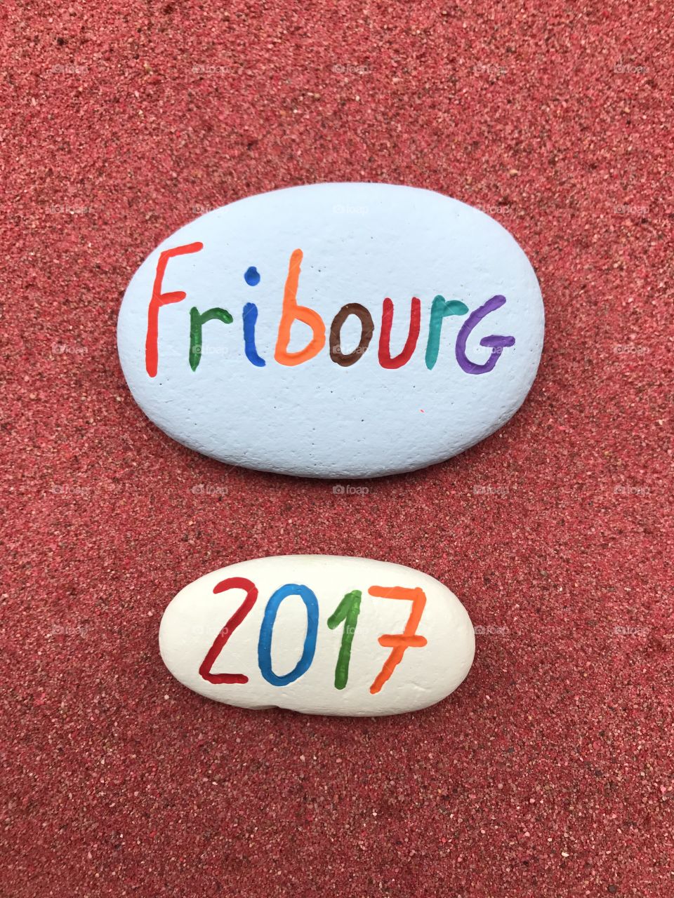 Fribourg 2017, souvenir on painted stones over red sand 
