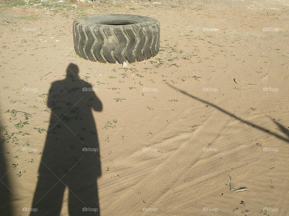 A lost wheel on sand.