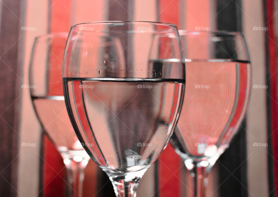 Glasses with water and colorful background