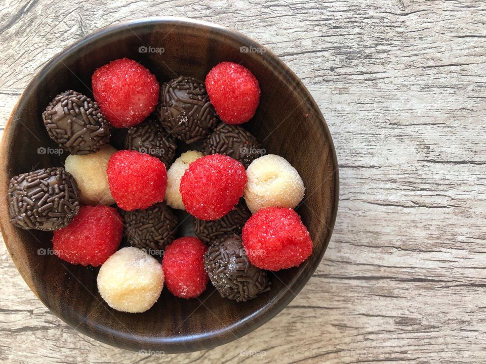 Strawberry, milk and chocolate candy (brigadeiro)