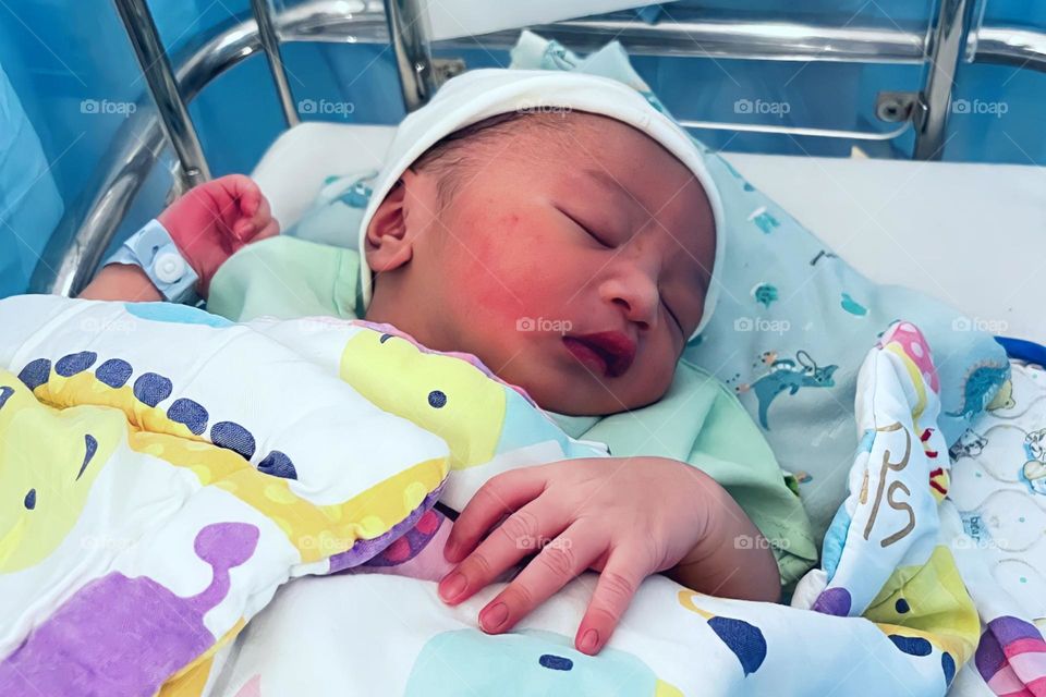 Cute baby boy sleeping in crib