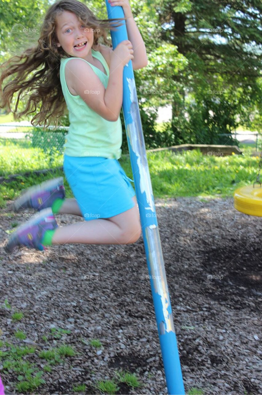 Girl moving on pole at park