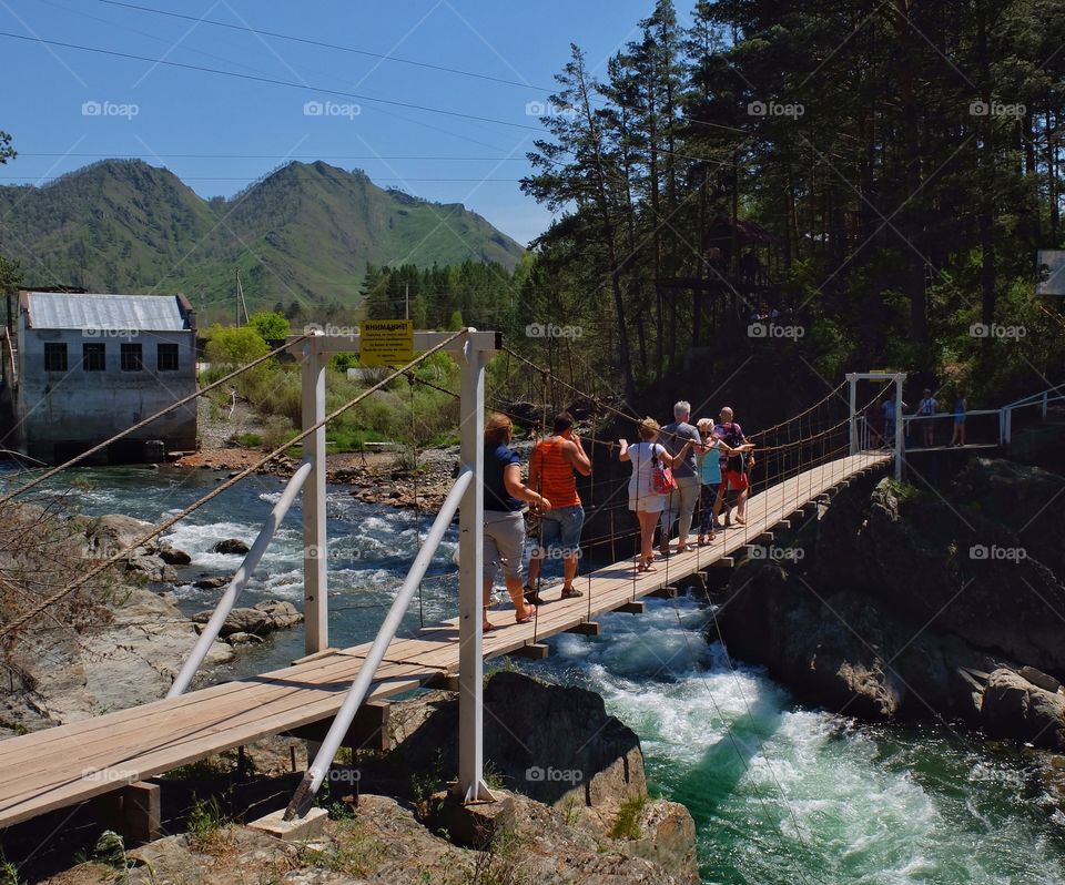 Hanging bridge and tourists. 