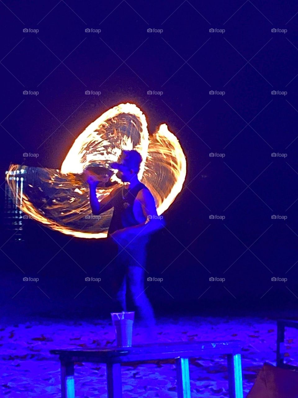 Man doing fire performance with low exposure 