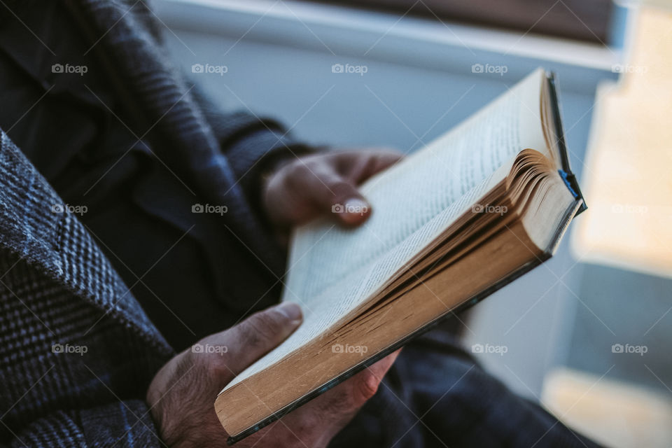 a man holds a book in his hand