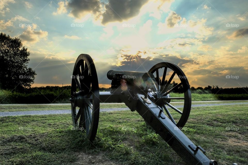 An old Civil War cannon points towards the sunset at Stones River National Battlefield in Murfreesboro, Tennessee. 