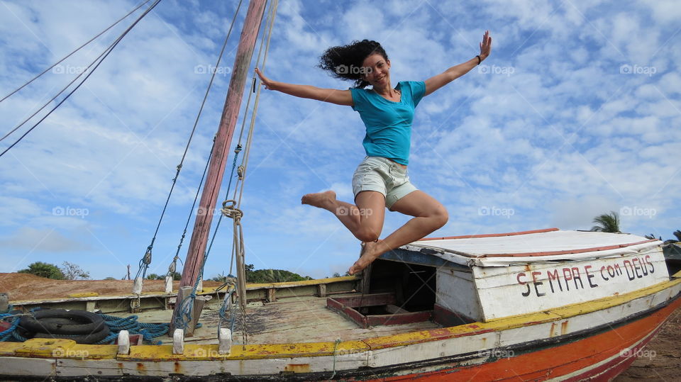 Woman jumping on boat