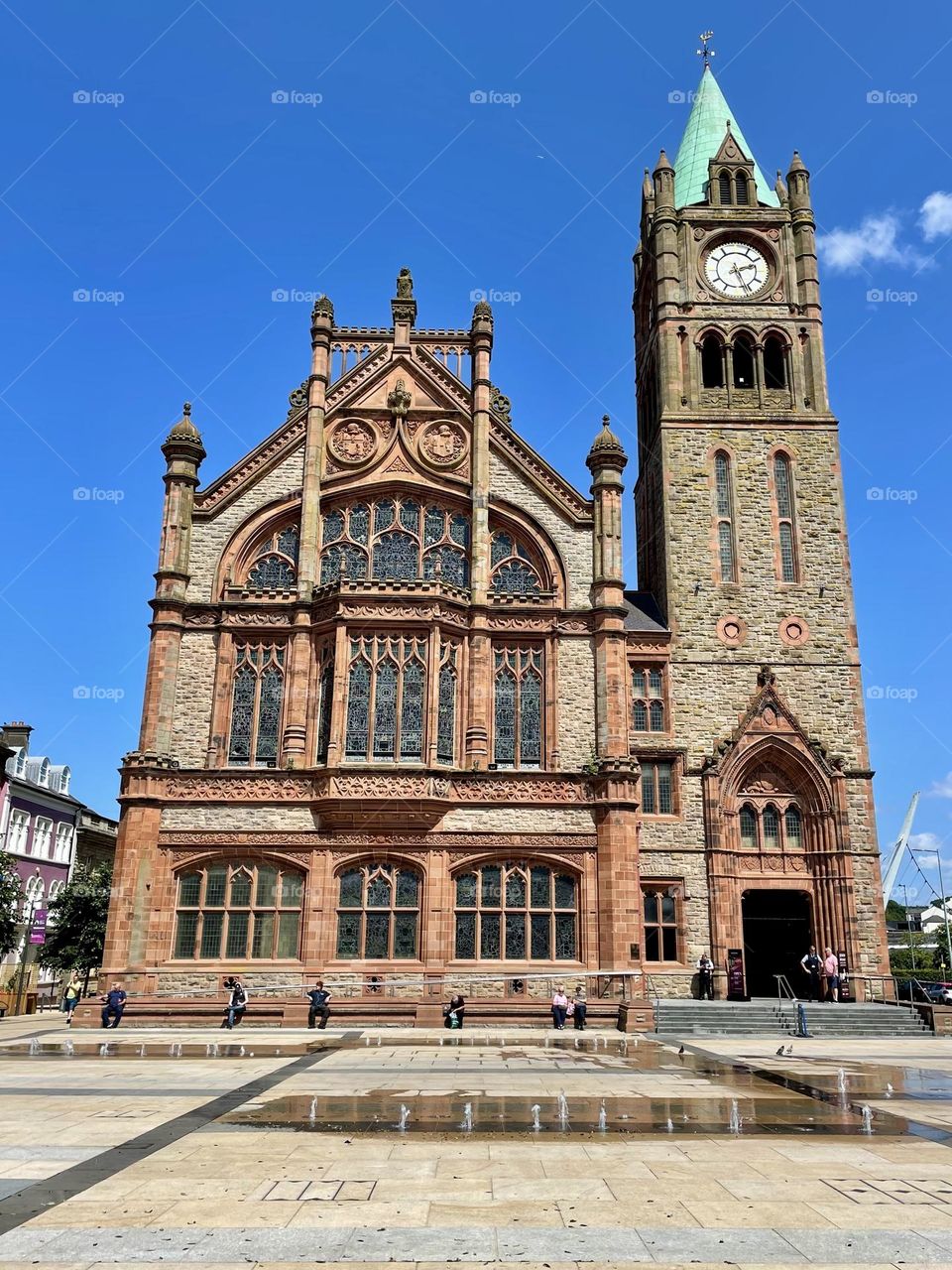 The Guildhall in Derry, Northern Ireland, fashioned in red sandstone in the Neo-Gothic architectural style.