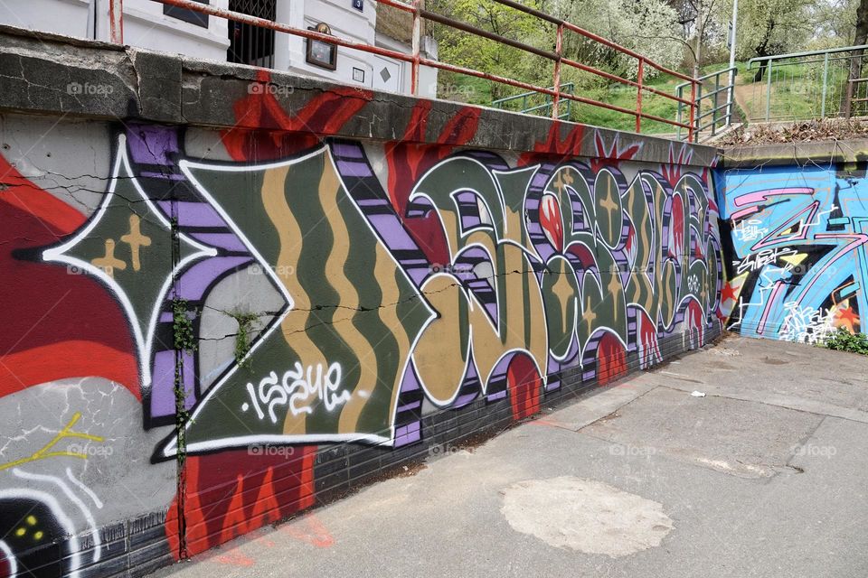 Colorful abstract graffiti and lettering on the wall by the path near Vitkov in Prague, Zizkov.