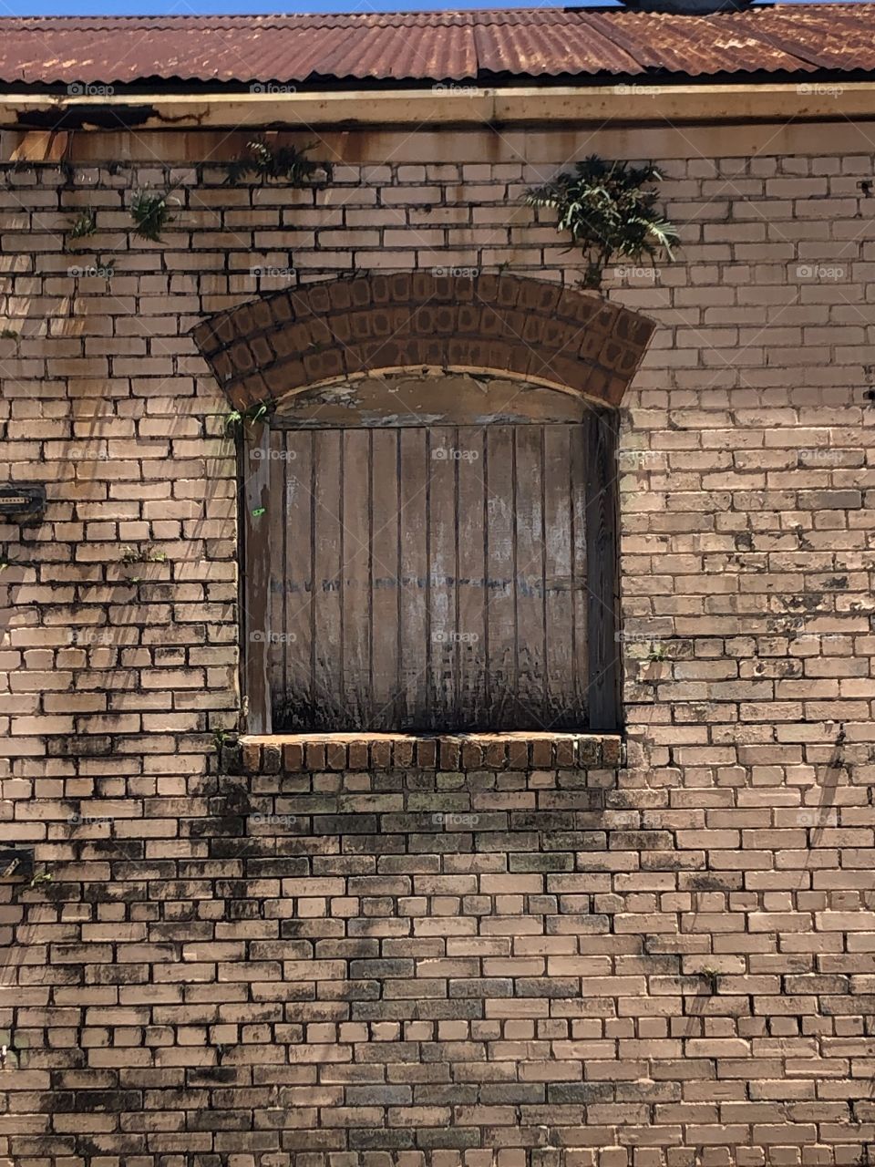 A very old brick building with shuttered window in Louisianna. 